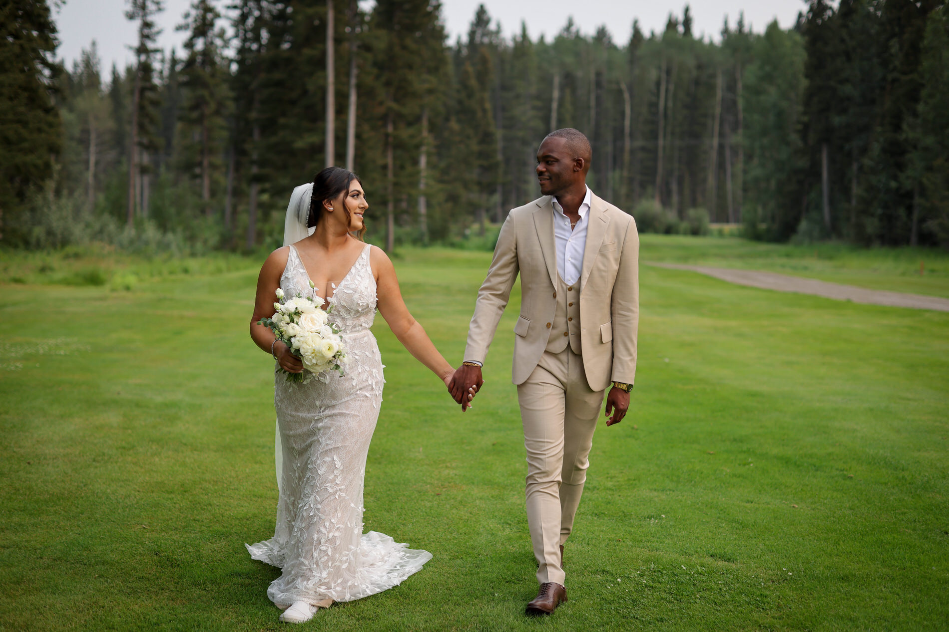 Bride and groom walk on Wintergreen golf course with amazing green grass on wedding day