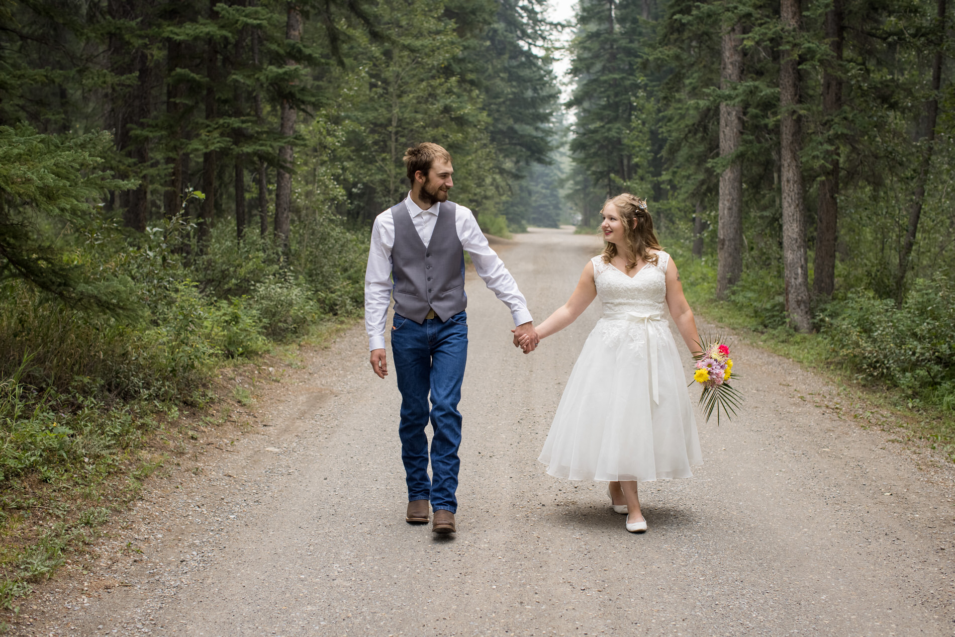 Bride and groom get married at a campground in banff National Park. They eloped with a small group of family and friends with an outdoor ceremony
