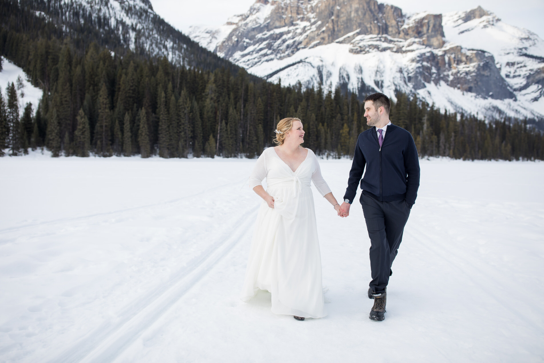 Winter wedding, bride and groom take outdoor photos at Emerald Lake Lodge